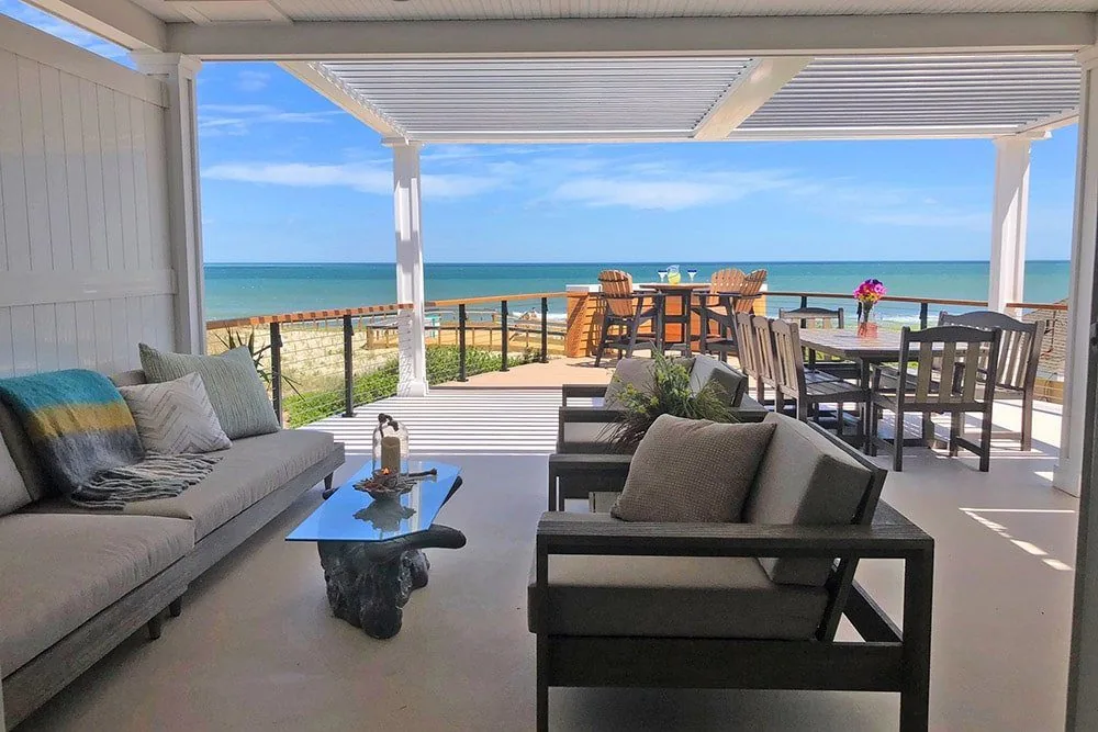 Louvered pergola over a coastal patio