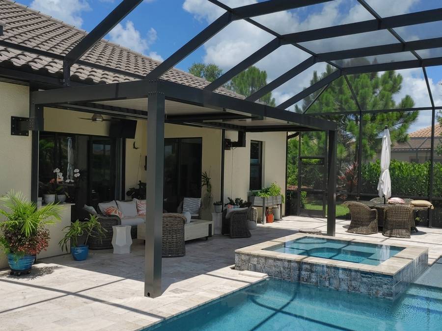 Bronze louvered pergola built against an existing pool screen enclosure over the spa end